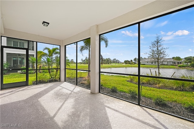 unfurnished sunroom with a water view