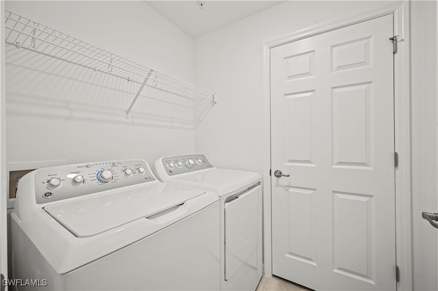 clothes washing area featuring independent washer and dryer