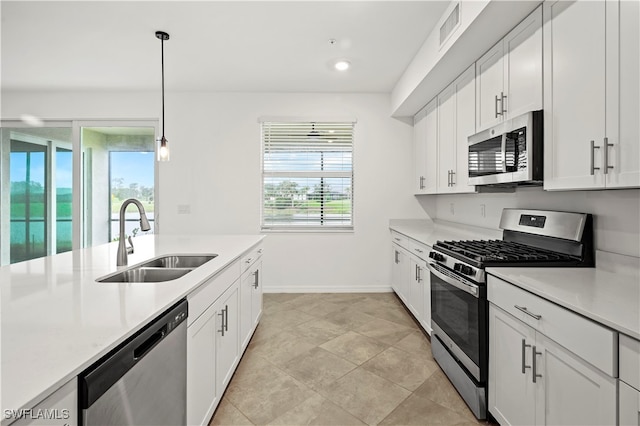 kitchen featuring white cabinetry, sink, plenty of natural light, and appliances with stainless steel finishes