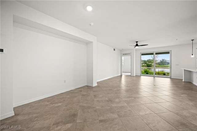 spare room featuring ceiling fan and light tile patterned floors