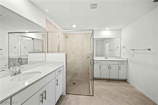 bathroom with tile patterned flooring, vanity, and walk in shower