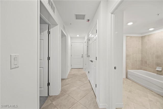 hall featuring light tile patterned floors