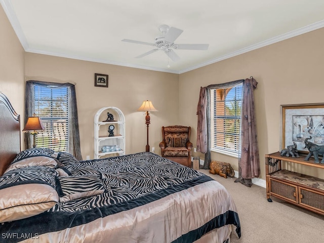 carpeted bedroom with ceiling fan and ornamental molding