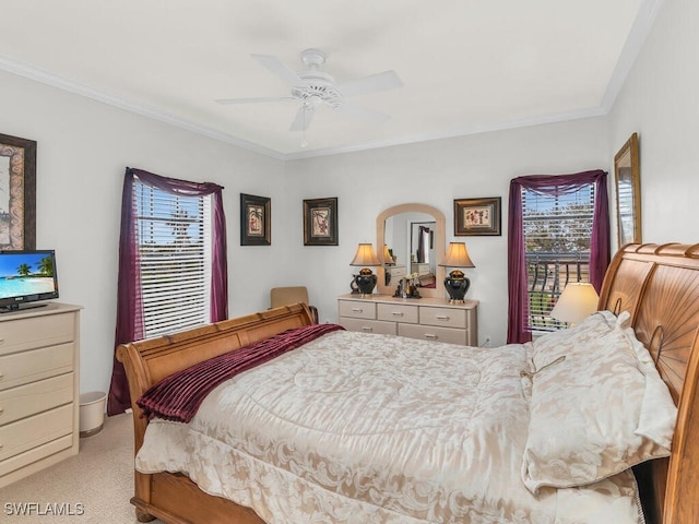 carpeted bedroom with ceiling fan and crown molding