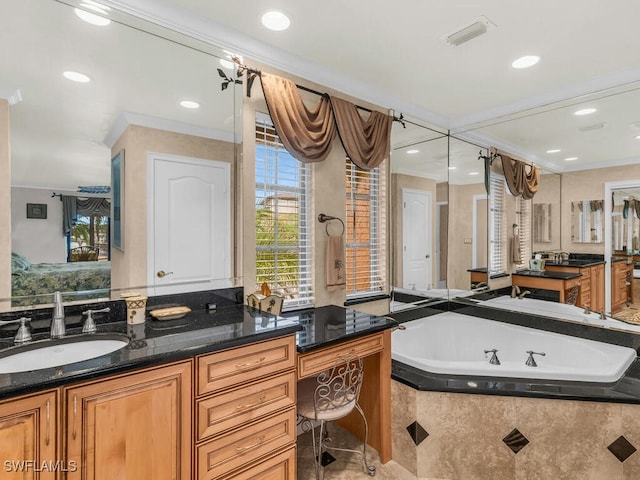 bathroom featuring vanity, ornamental molding, and tiled bath