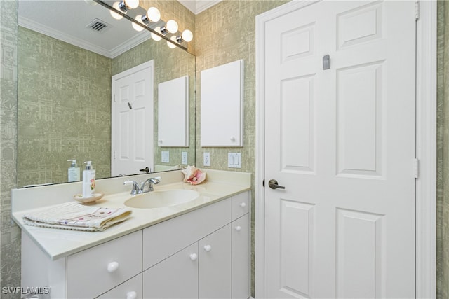 bathroom with crown molding and vanity