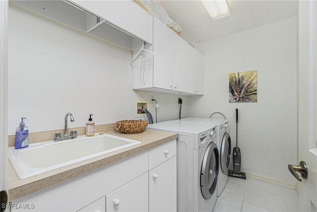 washroom with cabinets, independent washer and dryer, sink, and light tile patterned floors