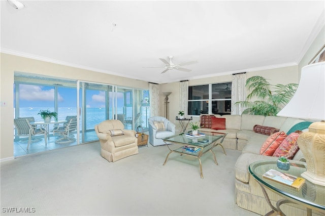 living room featuring crown molding, a water view, and a healthy amount of sunlight