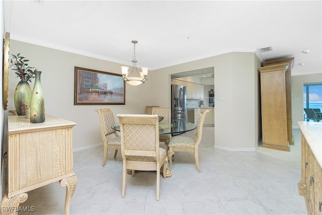 dining area featuring an inviting chandelier and crown molding