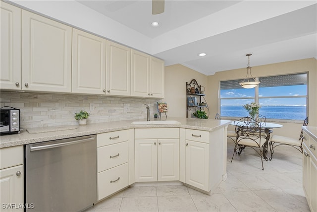 kitchen with a water view, sink, stainless steel dishwasher, tasteful backsplash, and decorative light fixtures