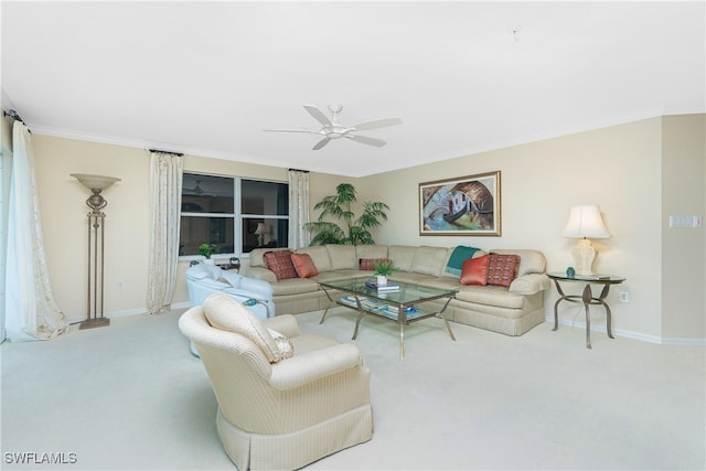 carpeted living room with ceiling fan and ornamental molding