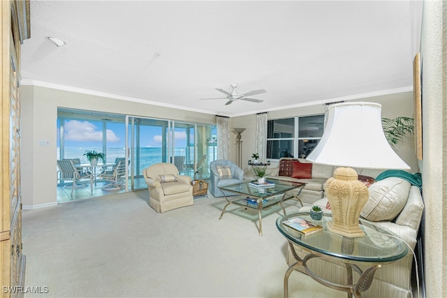 living room with carpet floors, ceiling fan, a water view, and ornamental molding