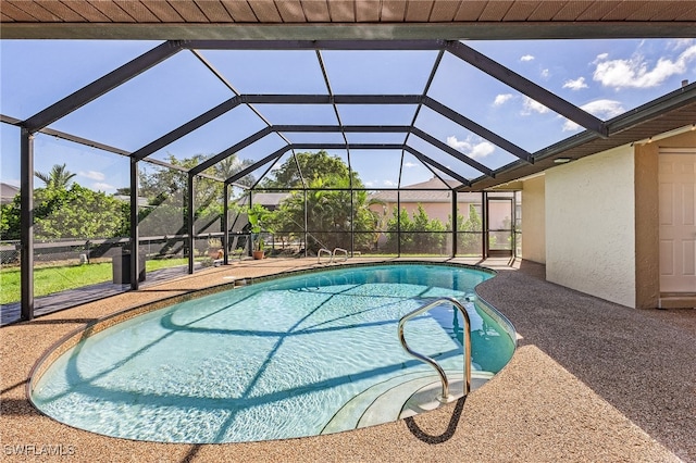 view of pool with glass enclosure