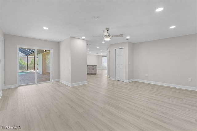 unfurnished living room with ceiling fan and light wood-type flooring