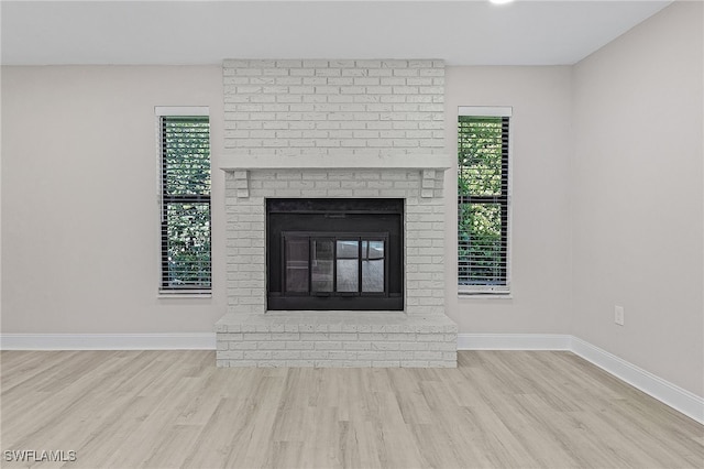 interior space with a fireplace and wood-type flooring