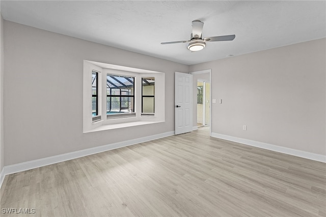 unfurnished room featuring light hardwood / wood-style floors and ceiling fan