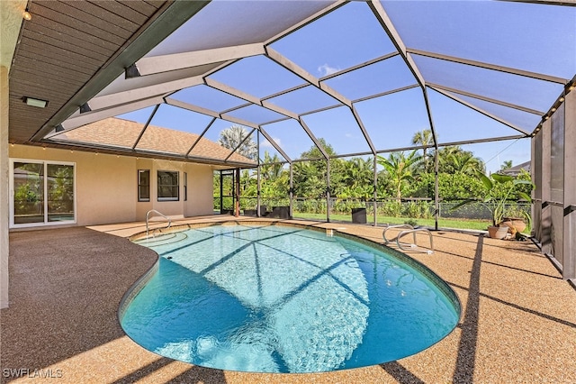 view of pool with a lanai and a patio area