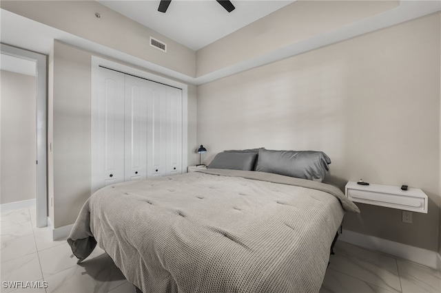 bedroom with ceiling fan and a closet