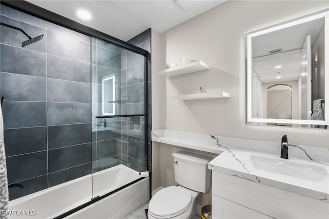 full bathroom with vanity, toilet, and enclosed tub / shower combo