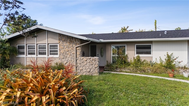 ranch-style home with a front yard