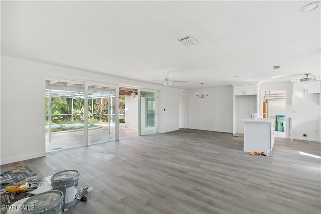 unfurnished living room featuring hardwood / wood-style floors and ceiling fan