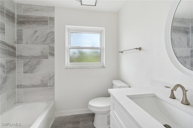 full bathroom with vanity, tiled shower / bath combo, and toilet