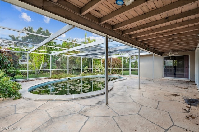 view of patio / terrace featuring glass enclosure and ceiling fan