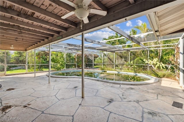 view of patio featuring glass enclosure and ceiling fan