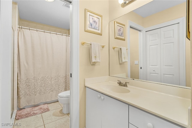 bathroom featuring tile patterned floors, vanity, and toilet