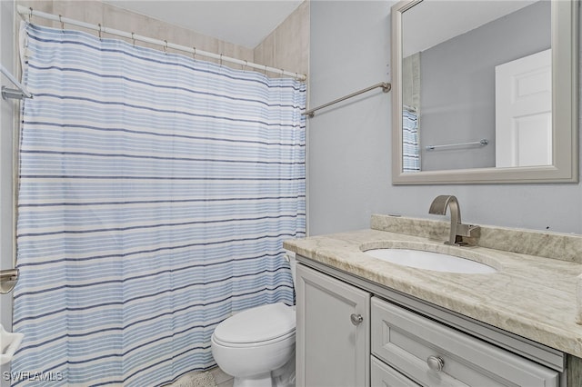 bathroom with vanity, toilet, and walk in shower