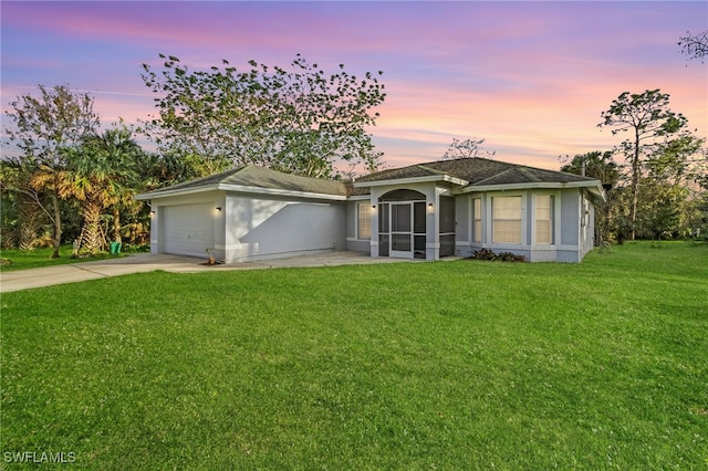 ranch-style house with a lawn and a garage