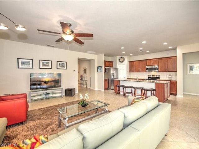 tiled living room with ceiling fan