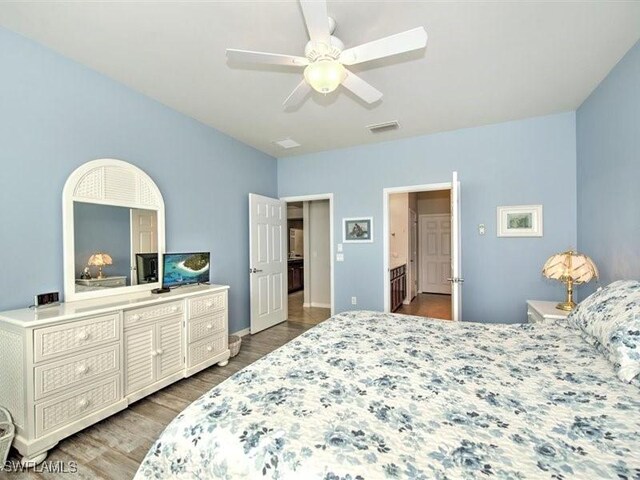 bedroom with ceiling fan and hardwood / wood-style flooring