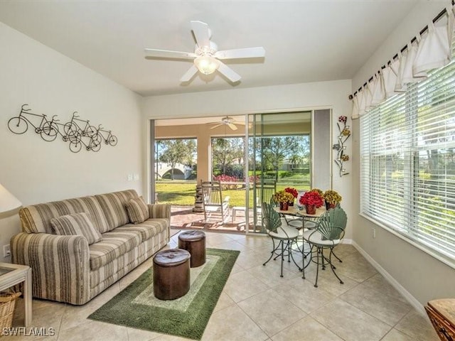 living room featuring ceiling fan and tile patterned flooring