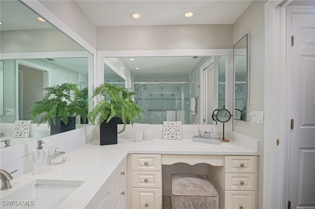 bathroom featuring vanity and an enclosed shower