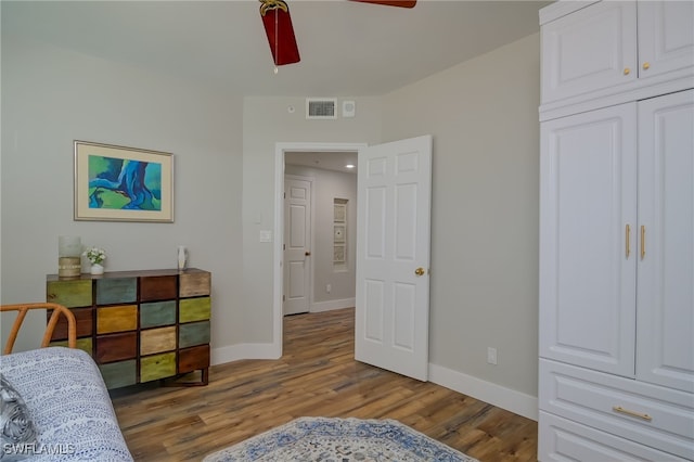 bedroom featuring ceiling fan, a closet, and light hardwood / wood-style flooring