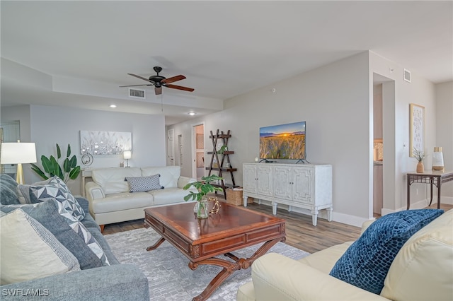 living room featuring ceiling fan and light hardwood / wood-style floors