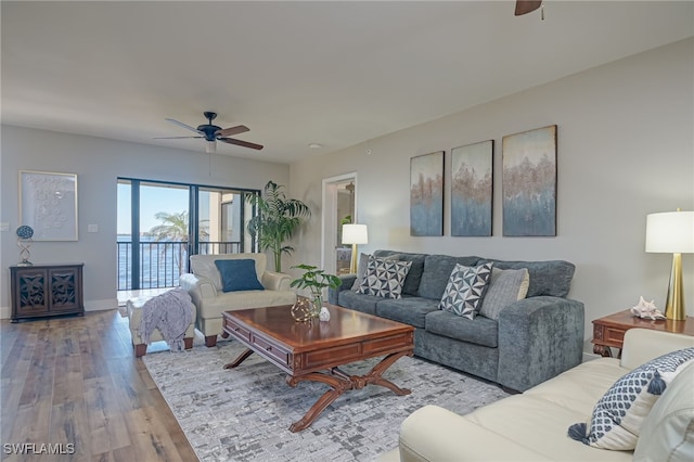 living room featuring ceiling fan and light hardwood / wood-style flooring