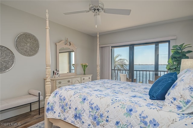 bedroom featuring access to exterior, wood-type flooring, a water view, and ceiling fan