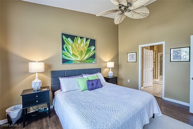 bedroom with wood-type flooring, ensuite bathroom, and ceiling fan