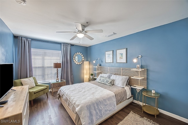 bedroom with ceiling fan and dark hardwood / wood-style flooring