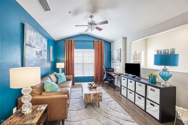 living room with hardwood / wood-style floors, lofted ceiling, ceiling fan, and a healthy amount of sunlight