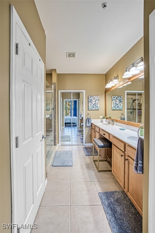 bathroom featuring tile patterned floors, vanity, and an enclosed shower