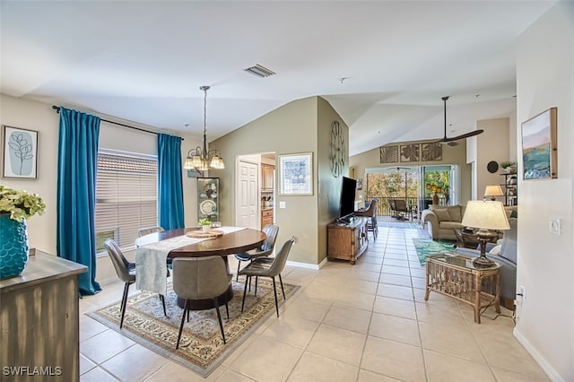 dining area featuring a chandelier, light tile patterned floors, and vaulted ceiling