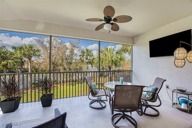 sunroom with ceiling fan and lofted ceiling