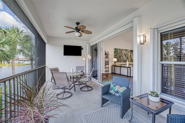 sunroom featuring ceiling fan