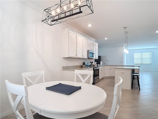 dining area with light tile patterned flooring and ornamental molding