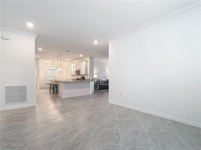 unfurnished living room featuring light tile patterned floors and crown molding