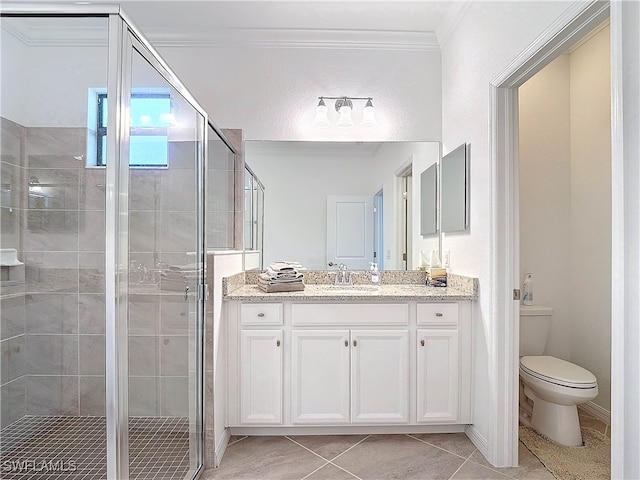 bathroom featuring tile patterned floors, crown molding, a shower with shower door, and toilet