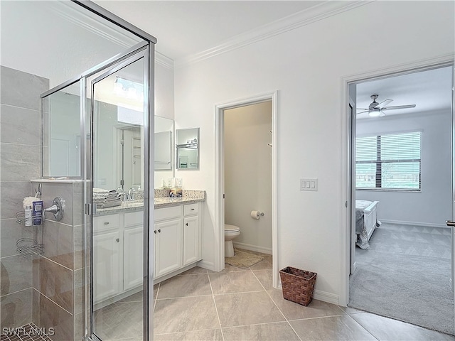 bathroom featuring tile patterned floors, vanity, ceiling fan, crown molding, and toilet